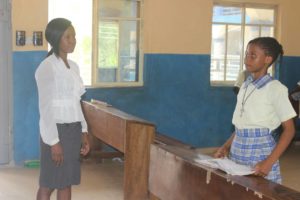 Alexis working with Ifeoma, her tutor for the BECE Exam.